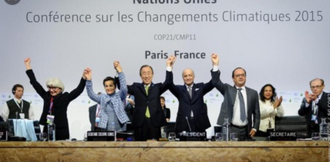 Leaders holding up their hands celebrating Paris Climate Agreement 2015